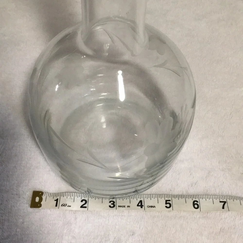 Floral etched glass decanter with stopper.